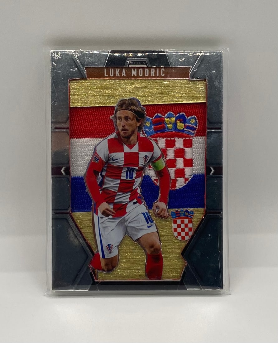 Luka Modric Custom Patch Card - Croatia National Team: A unique mosaic-style card featuring Croatian legend Luka Modric. This card features a prominent embroidered patch of the Croatian flag/crest. Displayed in a protective sleeve.