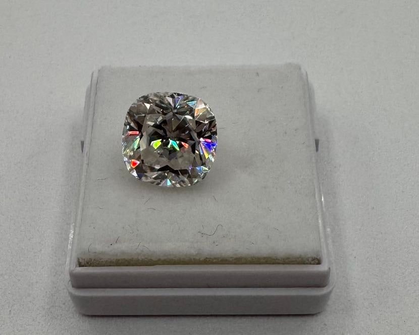 5.00ct Cushion Modified Brilliant Cut Moissanite - Color D w/ GRA Certificate: Presented is a high-carat 5.00 carat cushion modified brilliant cut moissanite. This stone features the sought-after "pillow" shape, combining the fire of a round brilliant with a classic,