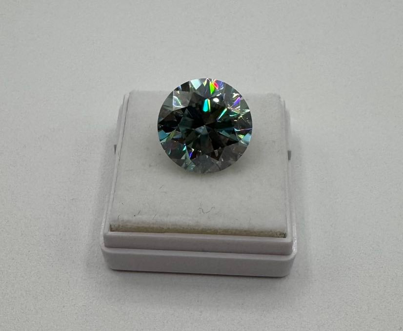 10.00ct Round Brilliant Cut Blue Moissanite - GRA Certified: An impressive 10.00 carat round brilliant cut moissanite gemstone featuring a vivid and saturated Deep Blue color. This stone displays intense light dispersion and "rainbow" flashes that make