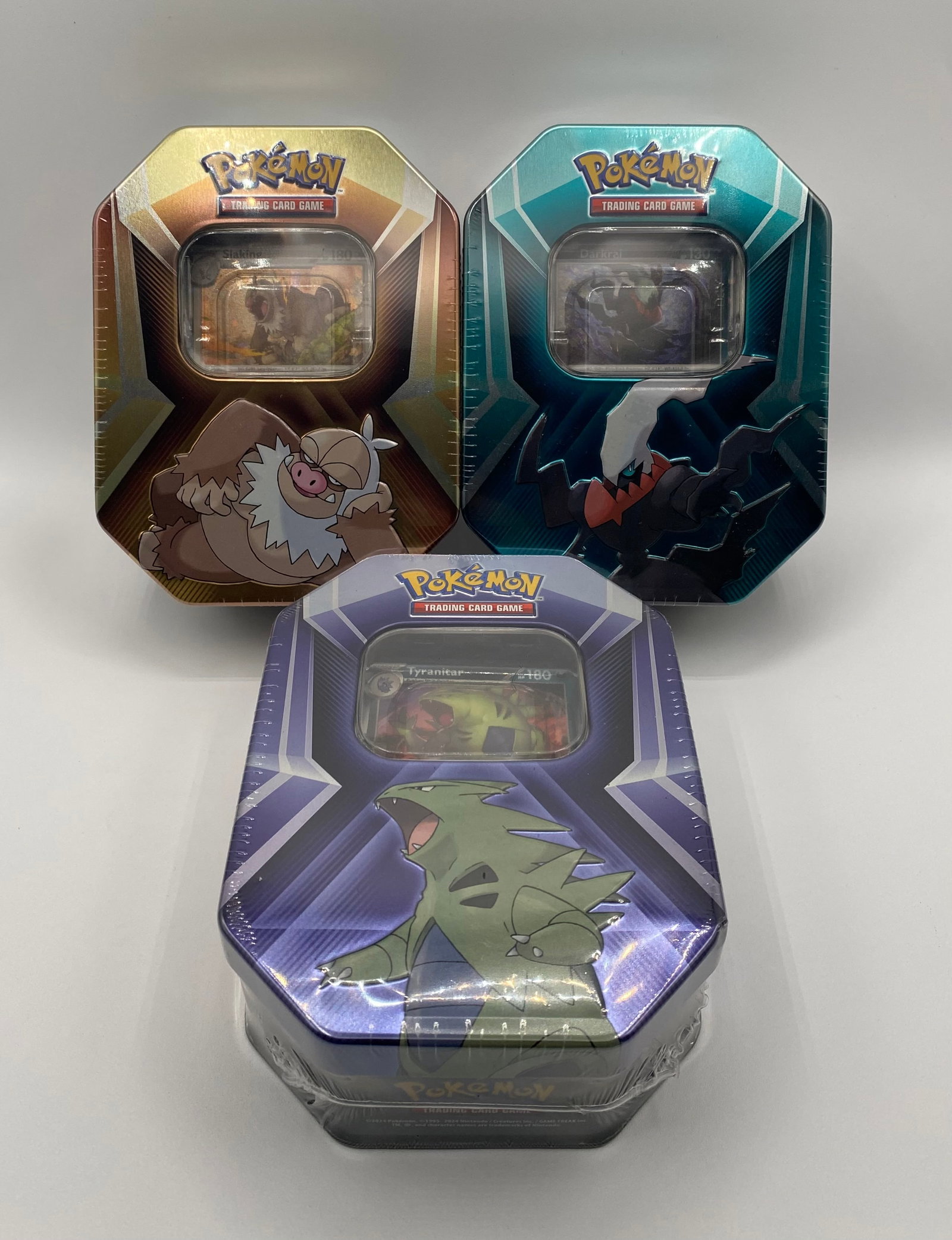 Trio of Factory-Sealed Pokémon TCG Tins: Slaking ex, Darkrai V & Tyranitar ex: Manufacturer: Nintendo / The Pokémon Company International Product Type: Trading Card Game (TCG) Specimen Tins Condition: Factory Sealed / Brand New Scope of Delivery: > A choice lot of three