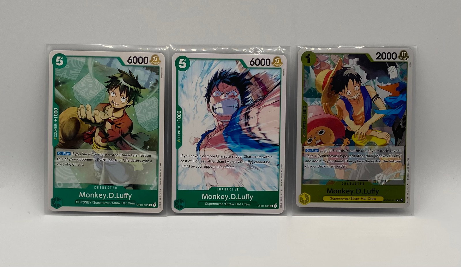 One Piece Card Game Lot (3pcs) - Monkey.D.Luffy Character Card Set: Game: One Piece Card Game (Bandai) Total Cards: 3 Character Featured: Monkey.D.Luffy Cards Included: Monkey.D.Luffy (Green / OP09-036 SR) - Odyssey/Supernovas/Straw Hat Crew Monkey.D.Luffy (Green /