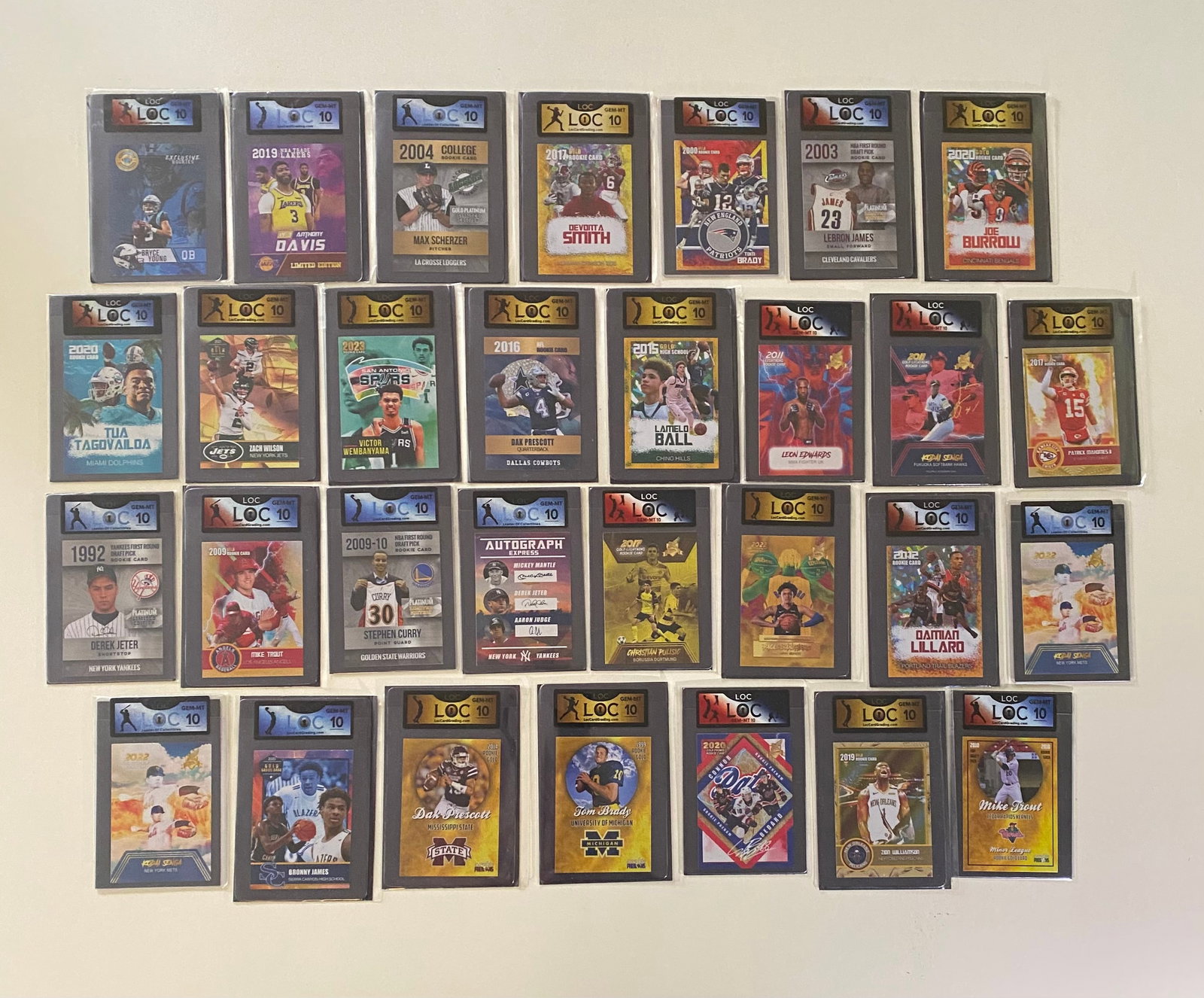 (23) Sports Cards - Features Stephen Curry Rookie, Patrick Mahomes, Victor Wembanyama, Derek Jeter: A massive and highly curated estate lot of 23 sports trading cards, all professionally encased and graded Gem Mint 10 by LOC (Local/Custom Grading). This specific lot features some of the most sought-