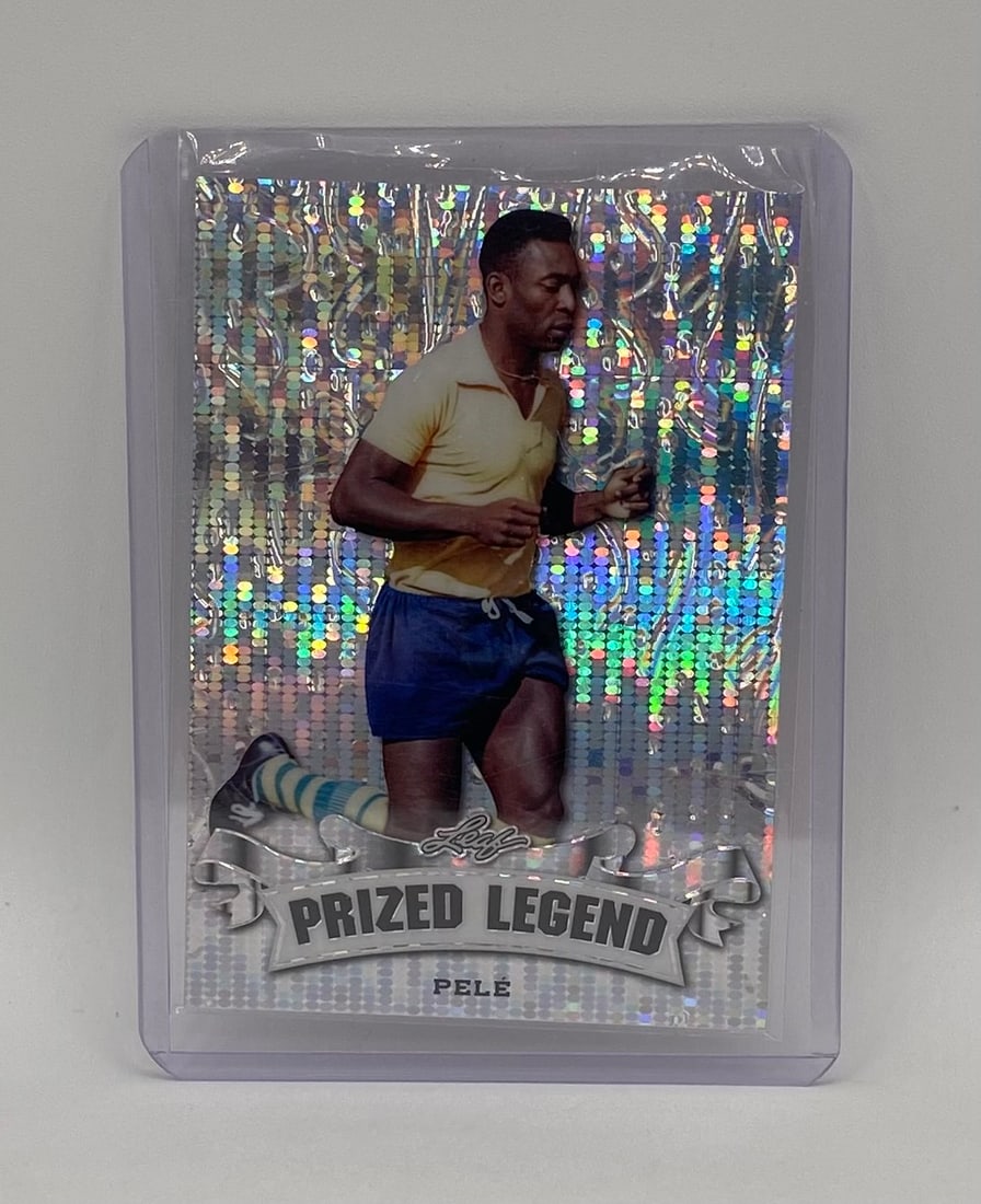 Pelé Silver Pulsar Refractor /25: A beautiful tribute to O Rei. This 2024 Leaf "Prized Legend" insert features Pelé in his iconic yellow and blue Brazil national team kit during his physical prime. Card Details: Features a