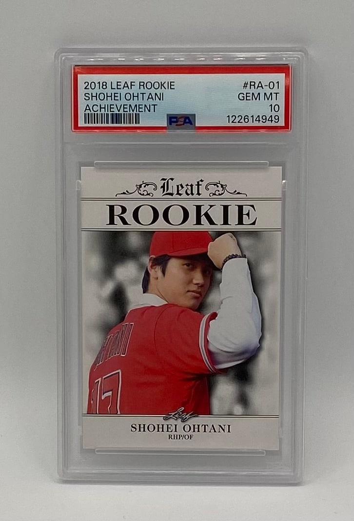 Shohei Ohtani Rookie Achievement PSA 10: A classic 2018 Leaf Rookie Shohei Ohtani "Achievement" #RA-01 card. This sought-after rookie-year insert highlights Ohtani in his Los Angeles Angels home red uniform, looking back over his shoulder.