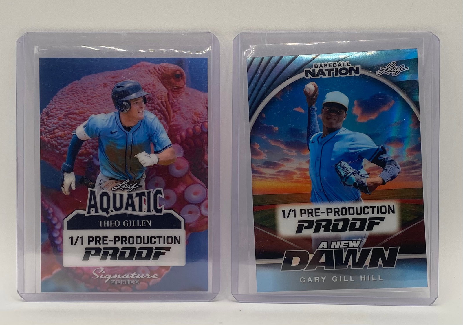 (2) Leaf Baseball Pre-Production Proofs - 1/1 One-of-One - Gillen & Gill Hill: An incredibly rare offering for baseball prospect collectors. This lot features two unique 1/1 Pre-Production Proof cards from Leaf, presented in protective top loaders. Theo Gillen: Leaf Aquatic