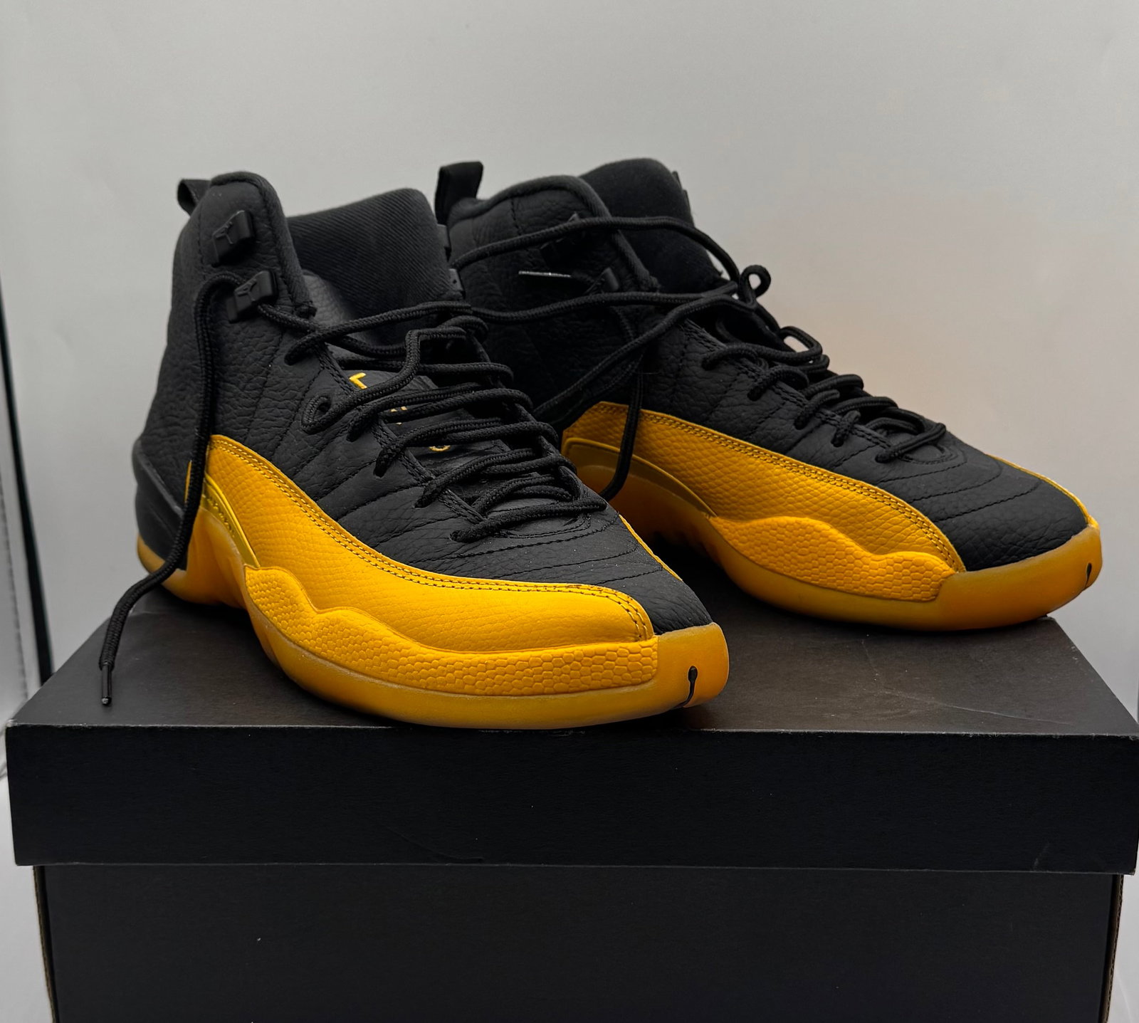 Air Jordan 12 Retro (GS) 'University Gold' Sneakers: Up for auction is a striking pair of Air Jordan 12 Retro (GS) in the highly sought-after 'University Gold' colorway (Style Code: 153265-070). This pair features the iconic contrast design, pairing a