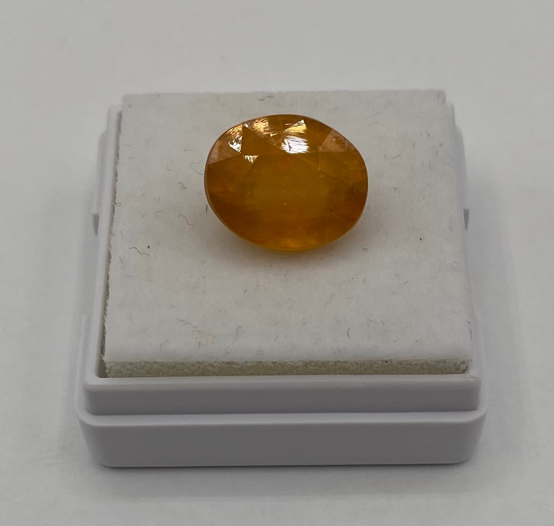 5.90 Ct. Honey-Yellow Sapphire - Loose Oval Cut Gemstone: Weight: Approx. 5.90 Carats Gemstone Type: Natural Sapphire Color: Honey-Yellow / Amber Shape/Cut: Oval Facet Clarity: Translucent with visible internal characteristics/natural inclusions (as