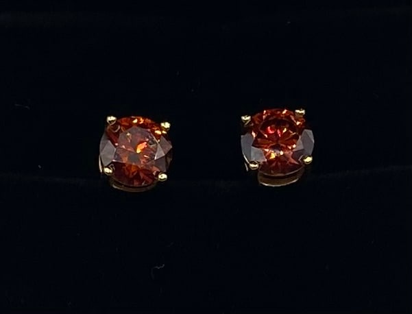 4.00 CTW Round Cut Cognac Moissanite Stud Earrings: Total Carat Weight: 4.00 CTW (2.00 carats per earring) Gemstone Type: Lab-Created Moissanite Stone Color: Deep Cognac / Vivid Orange-Brown Stone Cut: Brilliant Round Cut Metal Composition: 18K Yellow