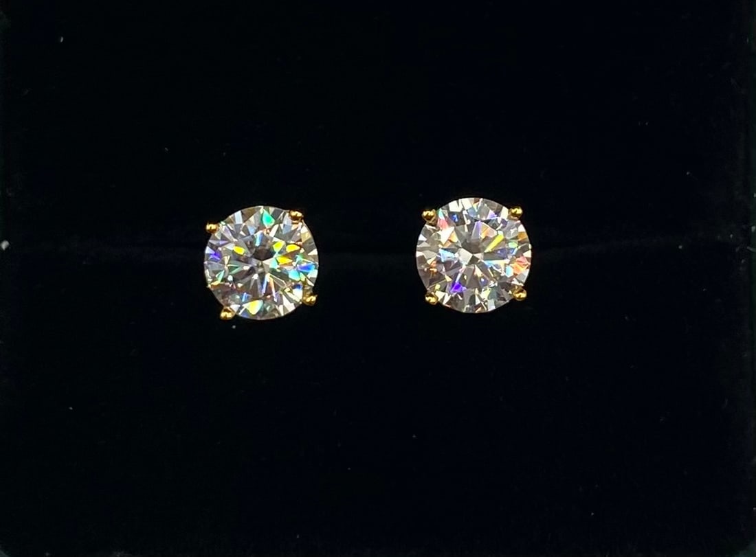 4.00 CTW Brilliant Round Cut White Moissanite Stud Earrings: Total Carat Weight: 4.00 CTW (2.00 carats per earring) Gemstone Type: Lab-Created Moissanite Stone Color: Classic Clear / D-F Color Equivalent Stone Cut: Brilliant Round Cut with exceptional fire and
