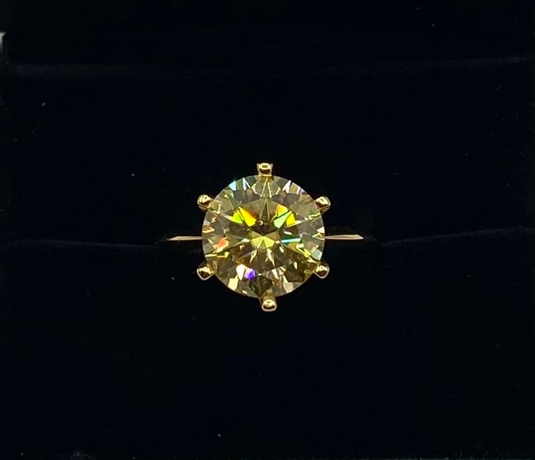 5.00 Ct Round Brilliant Cut Moissanite Solitaire Ring in 18K Yellow Gold Over Silver: Gemstone: Lab-Created Moissanite Carat Weight: Approx. 5.00 Carat Center Stone Cut: Round Brilliant Cut Metal: 18K Yellow Gold Plated over Solid .925 Sterling Silver Ring Size: 8 Certification: