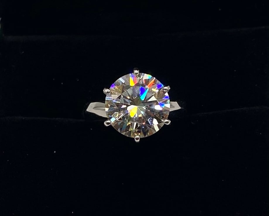 5.00 Ct Round Brilliant Cut Moissanite Solitaire Ring in 18K White Gold Over Silver: Gemstone: Lab-Created Moissanite Carat Weight: Approx. 5.00 Carat Center Stone Cut: Round Brilliant Cut Metal: 18K White Gold Plated over Solid .925 Sterling Silver Ring Size: 6 Certification: