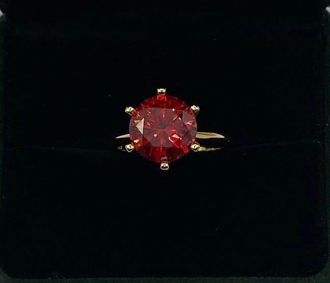 5.00 Ct Round Brilliant Cut Red Moissanite Solitaire Ring: Elevate your collection with this striking solitaire statement ring featuring a magnificent 5.00-carat round brilliant cut red moissanite. Known for its incredible fire and brilliance, this vibrant ge