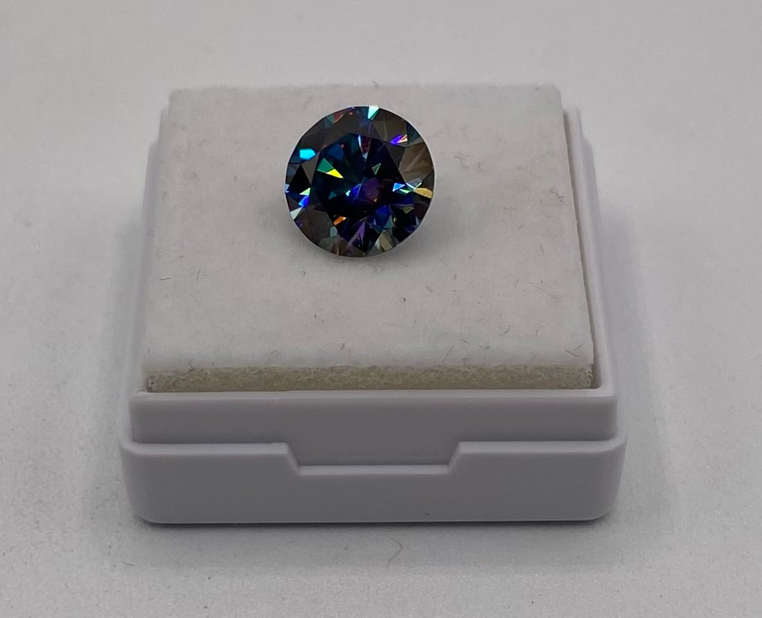 3.00 CT Round Brilliant Cut Moissanite - Deep Teal Blue/Rainbow - GRA Certified: Item Description: Up for auction is a magnificent 3.00 Carat Round Brilliant Cut loose Moissanite gemstone. This stunning stone features a unique, deep teal blue body color with striking rainbow fire