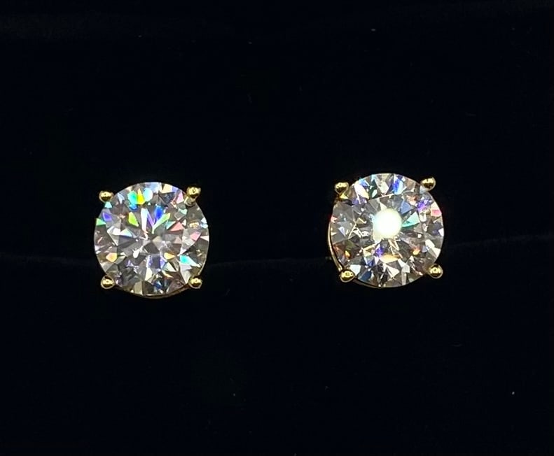 6.00 CTW Round Brilliant Cut Moissanite Stud Earrings: Total Carat Weight (CTW): 6.00 CTW (3.00 Carats per earring) Gemstone Type: Authentic Moissanite Cut: Round Brilliant Metal Composition: 18K Gold Plated over .925 Sterling Silver Setting: Classic