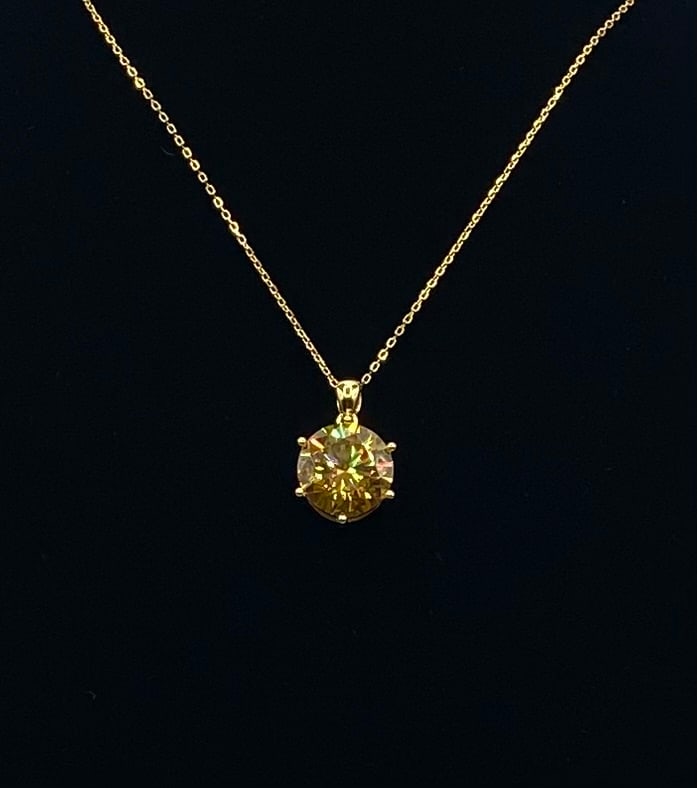 10 Carat Yellow Brilliant Moissanite Necklace - 18K Gold Plated Silver - GRA Cert: Center Stone: Authentic Moissanite Carat Weight: 10.00 Carats Cut: Round Brilliant Cut Metal Composition: 18K Gold Plated over .925 Sterling Silver Setting: 6-Prong Solitaire Pendant Condition: