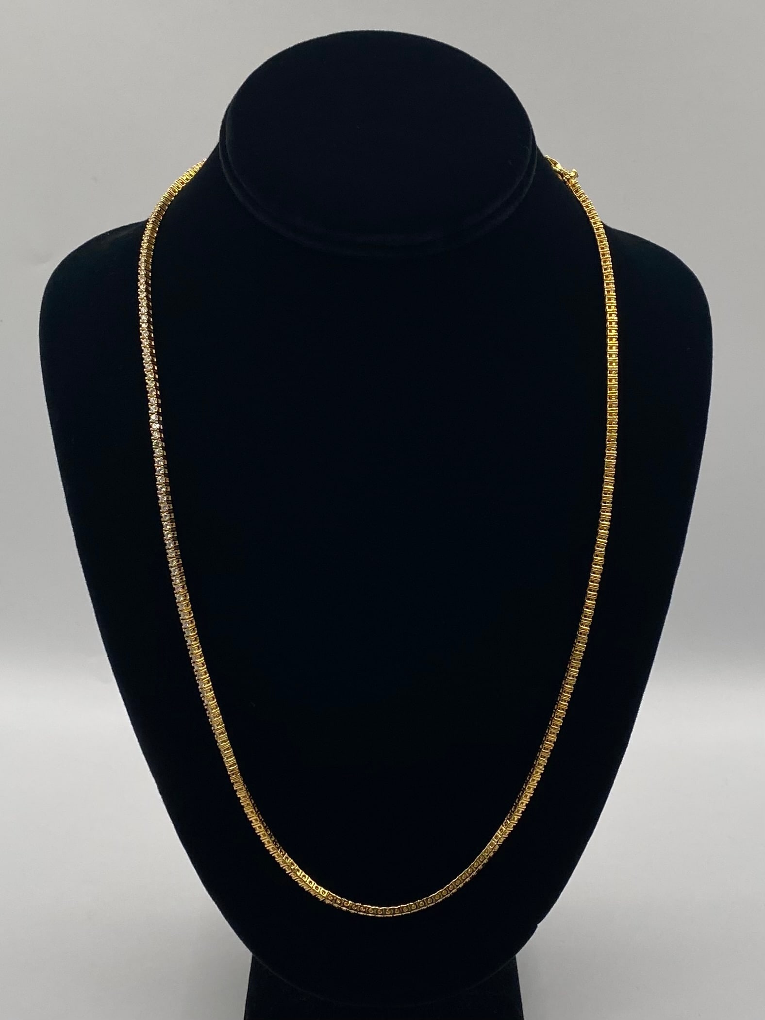 24" Moissanite Tennis Necklace 18K Gold Vermeil S925: Classic Single-Row Tennis Necklace Gemstone Type: Authentic Moissanite Stone Size: 2mm Metal Composition: 18K Gold Plating over Solid .925 Sterling Silver (Gold Vermeil) Necklace Length: 24