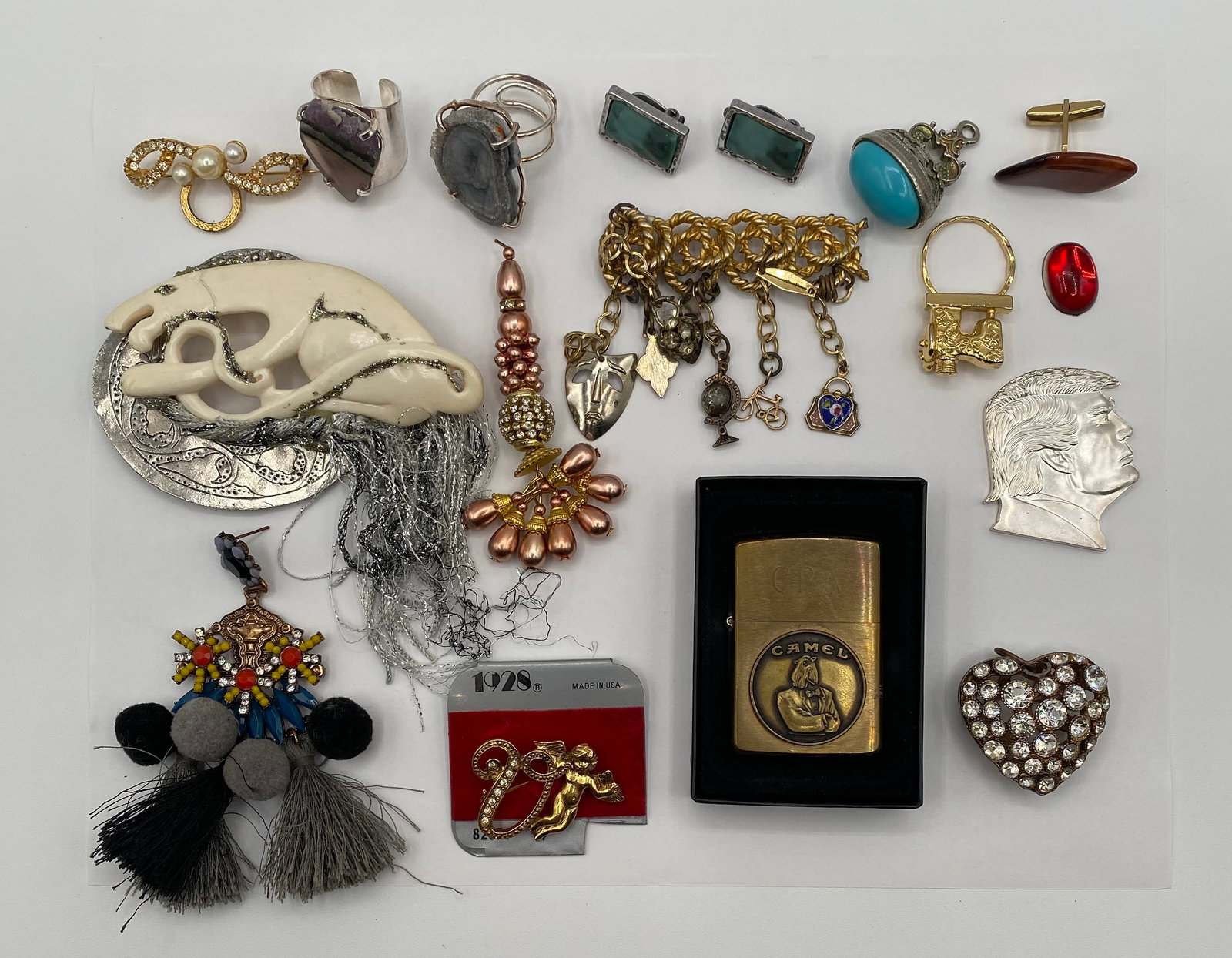 Vintage Camel Brass Lighter, Signed 1928 Co. Cupid Brooch, & Charm Pin Lot: A curated estate lot of highly collectible vintage vanity items, signed costume jewelry, and unique novelty accessories. This lot features excellent crossover appeal for tobacciana, vintage brand,