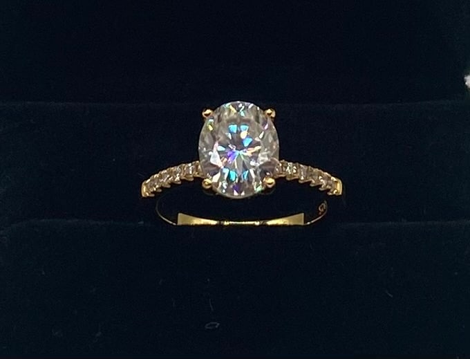 3.00ct Oval-Cut Moissanite Engagement Ring 18K Gold Plated Sterling Silver - Size 8: 3.00ct Oval-Cut Moissanite Engagement Ring 18K Gold Plated Sterling Silver - Size 8 Stone: 3.00 Carat genuine oval-cut Moissanite center stone with round brilliant accents along the band. Metal: 18K y