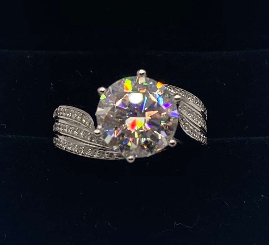 5 Carats VVS Moissanite Ring: 5.00CT Round VVS Moissanite Ring 18K Gold Plated SS - Size 8 1/2 . Center Stone Weight: 5.00 Carats Gemstone Type: Genuine Moissanite (Passes diamond tester) Metal Composition: 18K White Gold Plated