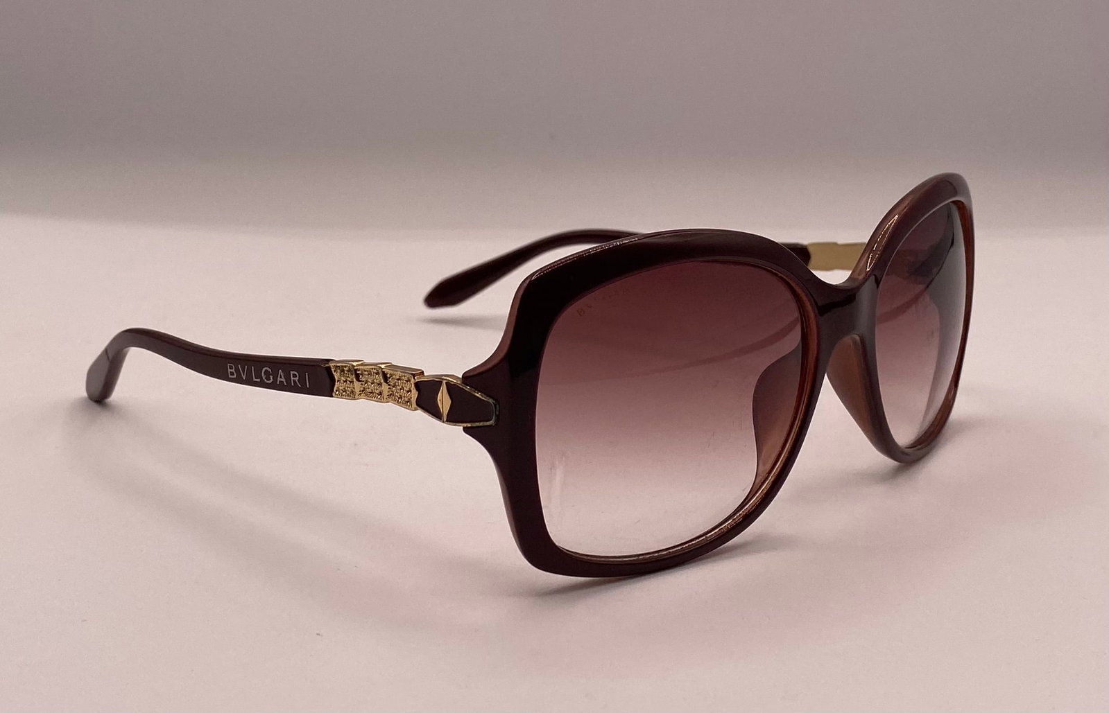 Bvlgari Sunglasses: Up for auction is a pair of authentic pre-owned Bvlgari women's sunglasses featuring a rich dark brown/plum acetate square butterfly frame, brown gradient lenses, and gold-tone side hinges