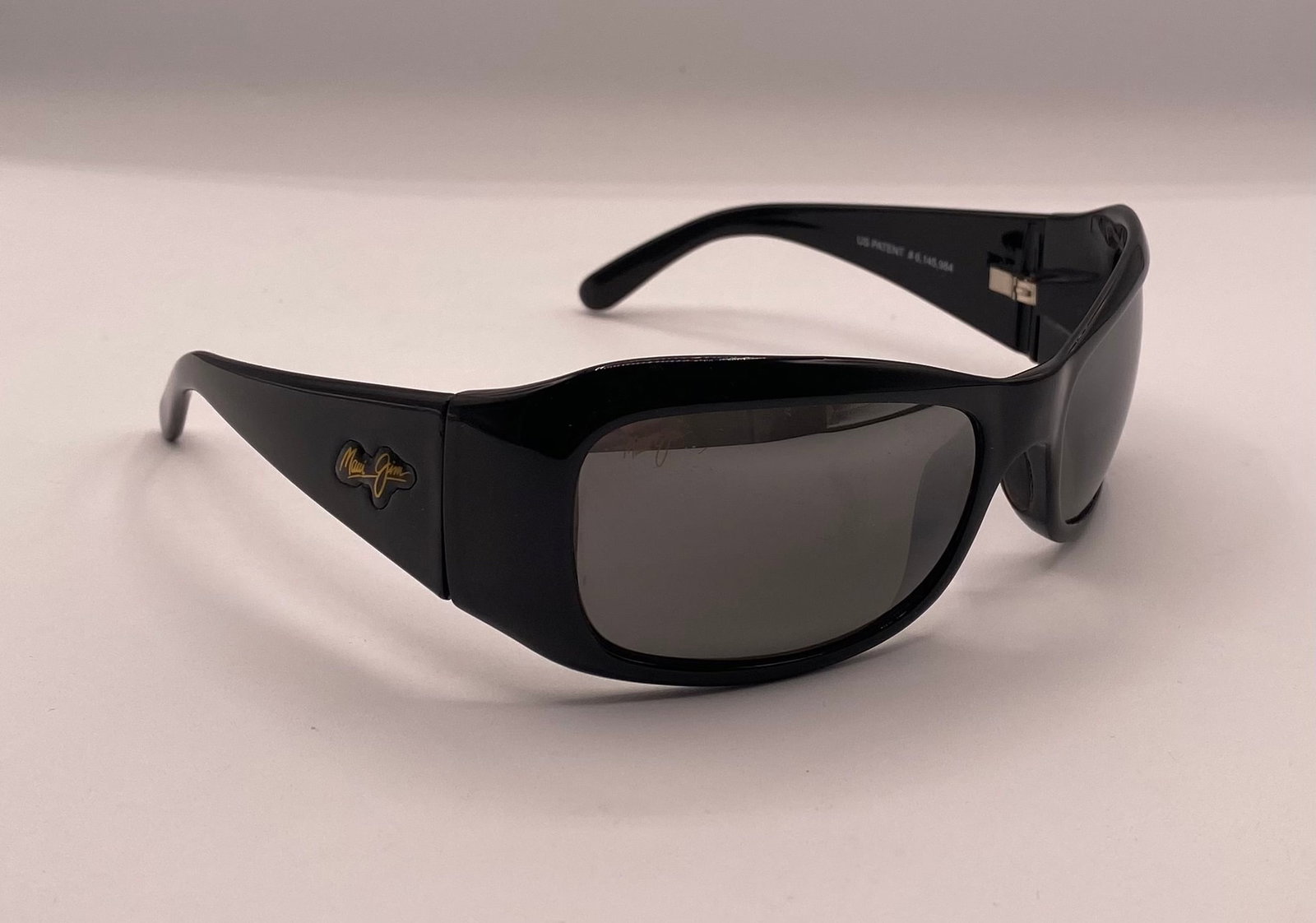 Maui Jim Sunglasses: Maui Jim Lagoon MJ 134-02 Gloss Black Polarized Wrap Sunglasses. Up for auction is an authentic pair of pre-owned Maui Jim "Lagoon" polarized wrap sunglasses (Model: MJ 134-02). These feature a