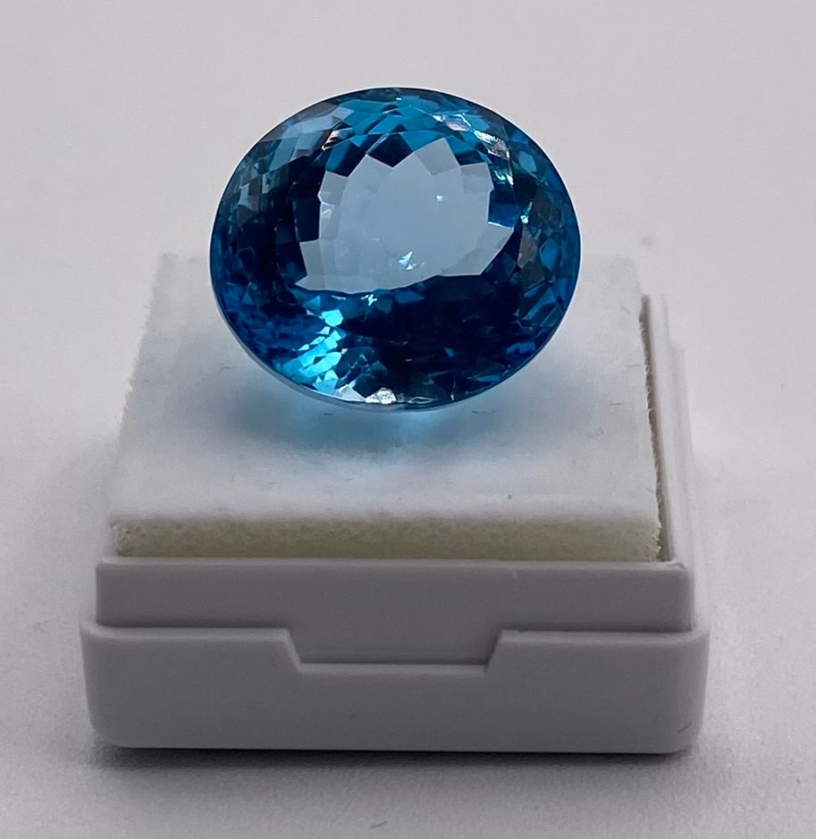 Certified 26.72 Cts Natural Blue Topaz: Gem Type: Natural Topaz Weight: 26.72 Cts Color: Blue Shape / Cut: Oval / Mixed Cut Dimensions: 17.79 x 16.33 x 11.53 mm Refractive Index: 1.610 - 1.620 (Birefringence 0.010) Certification: