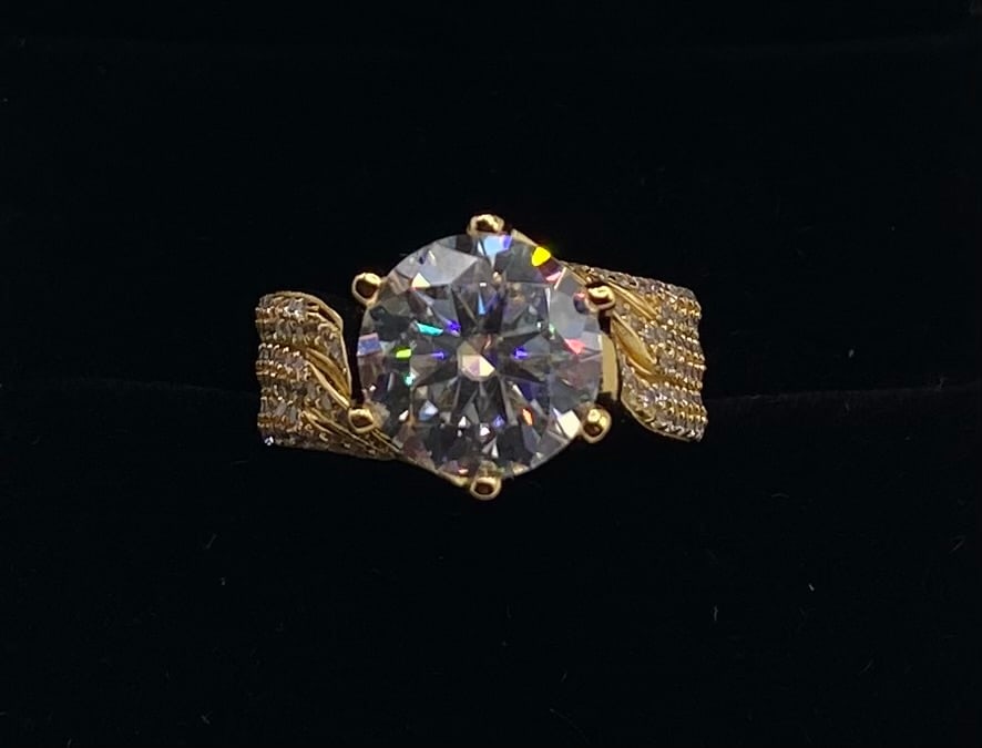 5ct VVS1 Color D Moissanite Statement Ring w/ Certificate: 5ct VVS1 Color D Moissanite Statement Ring w/ Certificate - Size 8. Main Stone: 5.0 Carat, Premium VVS1 Clarity, Color D Moissanite Cut: Round Brilliant Cut Setting: 6-Prong Setting on a wide gold-ton