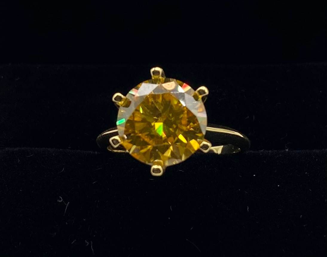 10 Carats Yellow VVS Ring: 18K Gold Plated Sterling Silver Ring — 0.10 CTW VVS Yellow Moissanite (Size 8) Key Details Material: 18K Gold Plated .925 Sterling Silver Main Stone: Lab-Created VVS Moissanite Total Carat