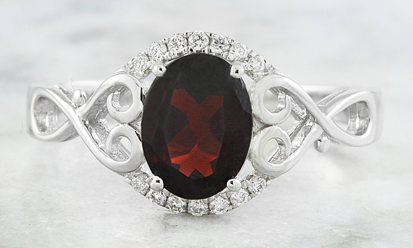 1.27 CTW Garnet 14K White Gold Diamond Ring: 1.27 CTW Garnet 14K White Gold Diamond Ring Manufacturer's Suggested Retail Price: $ 900.00 Stamped: 14K Total Ring Weight: 2.3 Grams Garnet Weight 1.21 Carat (8.00x6.00 Millimeters) Diamond Weight: 0