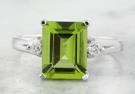 2.26 CTW Peridot 18K White Gold Diamond Ring: 2.26 CTW Peridot 18K White Gold Diamond Ring Manufacturer's Suggested Retail Price: $ 1900.00 Stamped: 18K Total Ring Weight: 2.9 Grams Peridot Weight 2.20 Carat (9.20x7.20 Millimeters)