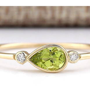 0.58 CTW Natural Peridot And Diamond Ring In 18K Yellow Gold: 0.58 CTW Natural Peridot And Diamond Ring In 18K Yellow Gold Manufacturer's Suggested Retail Price: $ 1200.00 Stamped: 18K Ring Size: 10 Total Ring Weight: 1.1 Grams Diamond Weight: Total