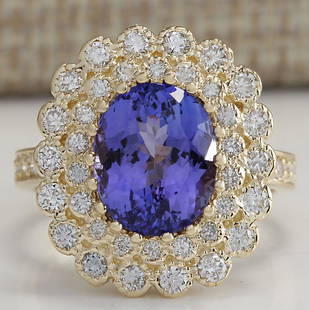 5.42 CTW Natural Blue Tanzanite And Diamond Ring In 14K Yellow Gold: 5.42 CTW Natural Blue Tanzanite And Diamond Ring In 14K Yellow Gold Manufacturer's Suggested Retail Price: $ 5500.00 Stamped: 14K Ring Size: 6.75 Total Ring Weight: 8.2 Grams Diamond Weight: