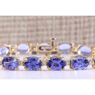 29.50 CTW Natural Tanzanite And Diamond Bracelet In 14k Solid Yellow Gold: 29.50 CTW Natural Tanzanite And Diamond Bracelet In 14k Solid Yellow Gold Manufacturer's Suggested Retail Price: $ 9800.00 Stamped: 14K Bracelet Width: 6.77mm Bracelet Length: 7.0 Inches 