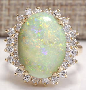 6.31 CTW Natural Australian Opal And Diamond Ring 14K Solid Yellow Gold: 6.31 CTW Natural Australian Opal And Diamond Ring 14K Solid Yellow Gold Manufacturer's Suggested Retail Price: $ 4600.00 Stamped: 14K Ring Size: 6.75 Total Ring Weight: 7 Grams Diamond
