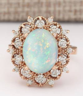4.15 CTW Natural Opal And Diamond Ring In 14k Rose Gold: 4.15 CTW Natural Opal And Diamond Ring In 14k Rose Gold Manufacturer's Suggested Retail Price: $ 3800.00 Stamped: 14K Ring Size: 7.25 Total Ring Weight: 8.1 Grams Diamond Weight: Total
