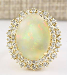 9.91 CTW Natural Opal And Diamond Ring In 14k Yellow Gold: 9.91 CTW Natural Opal And Diamond Ring In 14k Yellow Gold Manufacturer's Suggested Retail Price: $ 6400.00 Stamped: 14K Ring Size: 6 Total Ring Weight: 9.2 Grams Diamond Weight: Total