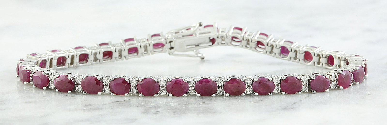 14.00 CTW Ruby 18K White Gold Diamond Bracelet: 14.00 CTW Ruby 18K White Gold Diamond Bracelet Manufacturer's Suggested Retail Price: $ 3200.00 Stamped: 18K Total Bracelet Weight: 12 Grams Bracelet Length: 7.0 Inches Ruby Weight: 13.00 Carat (5.00x