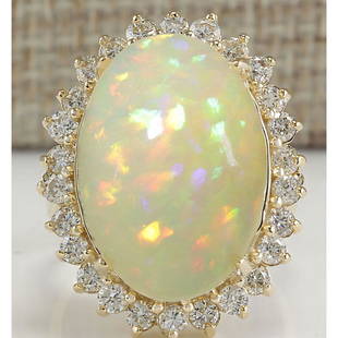 12.51 CTW Natural Ethiopian Opal And Diamond Ring In 14K Solid Yellow Gold: 12.51 CTW Natural Ethiopian Opal And Diamond Ring In 14K Solid Yellow Gold Manufacturer's Suggested Retail Price: $ 5900.00 Stamped: 14K Ring Size: 6.75 Total Ring Weight: 9.2 Grams Diamond