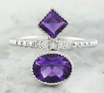 1.82 CTW Amethyst 14K White Gold Diamond Ring: 1.82 CTW Amethyst 14K White Gold Diamond Ring Manufacturer's Suggested Retail Price: $ 1400.00 Stamped: 14K Total Ring Weight: 3.7 Grams Amethyst Weight 1.70 Carat (9.00x7.00, 7.00x7.00