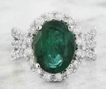 6.86 CTW Emerald 18K White Gold Diamond Ring: 6.86 CTW Emerald 18K White Gold Diamond Ring Manufacturer's Suggested Retail Price: $ 6700.00 Stamped: 18K Total Ring Weight: 7.6 Grams Emerald Weight 5.63 Carat (12.50x9.60 Millimeters)