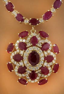43.35 CTW Ruby 14K Yellow Gold Diamond Necklace: 43.35 CTW Ruby 14K Yellow Gold Diamond Necklace Manufacturer's Suggested Retail Price: $ 13800.00 Stamped: 14K Total Necklace Weight: 32.8 Grams Necklace Length: 19 Inches Center Ruby Weight: