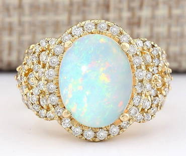 4.86 CTW Natural Opal And Diamond Ring In 14k Yellow Gold: 4.86 CTW Natural Opal And Diamond Ring In 14k Yellow Gold Manufacturer's Suggested Retail Price: $ 4700.00 Stamped: 14K Ring Size: 7.5 Total Ring Weight: 10.4 Grams Diamond Weight: Total