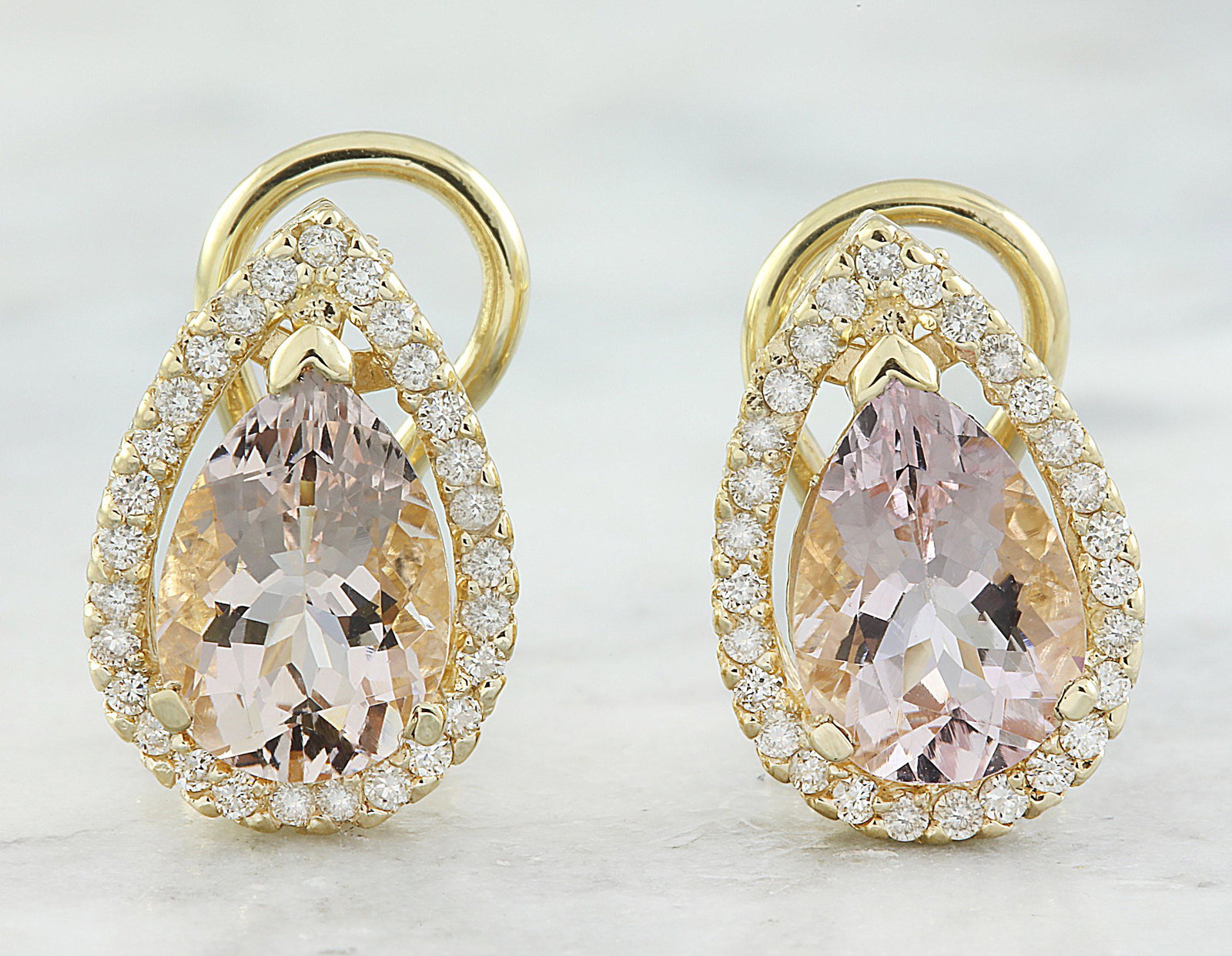 4.30 CTW Morganite 14K Yellow Gold Diamond Earrings: 4.30 CTW Morganite 14K Yellow Gold Diamond Earrings Manufacturer's Suggested Retail Price: $ 3500.00 Stamped: 14K Total Earrings Weight: 6.1 Grams Morganite Weight: 3.85 Carat (11.00x7.20 Millimeters)