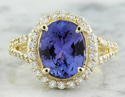 1.95 CTW Tanzanite 14K Yellow Gold Diamond Ring: 1.95 CTW Tanzanite 14K Yellow Gold Diamond Ring Manufacturer's Suggested Retail Price: $ 3500.00 Stamped: 14K Total Ring Weight: 4 Grams Tanzanite Weight 1.50 Carat (9.00x7.00 Millimeters)
