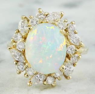 4.95 CTW Opal 18K Yellow Gold Diamond Ring: 4.95 CTW Opal 18K Yellow Gold Diamond Ring Manufacturer's Suggested Retail Price: $ 4900.00 Stamped: 18K Total Ring Weight: 7 Grams Opal Weight 3.45 Carat (12.00x10.00 Millimeters) Diamond