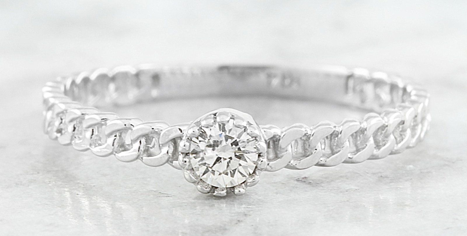 0.10 CTW Diamond 14K White Gold Solitaire Ring: 0.10 CTW Diamond 14K White Gold Solitaire Ring Manufacturer's Suggested Retail Price: $ 1100.00 Stamped: 14K Total Ring Weight: 1.2 Grams Diamond Weight: 0.10 carat (F-G Color, VS2-SI1 Clarity ) Face 