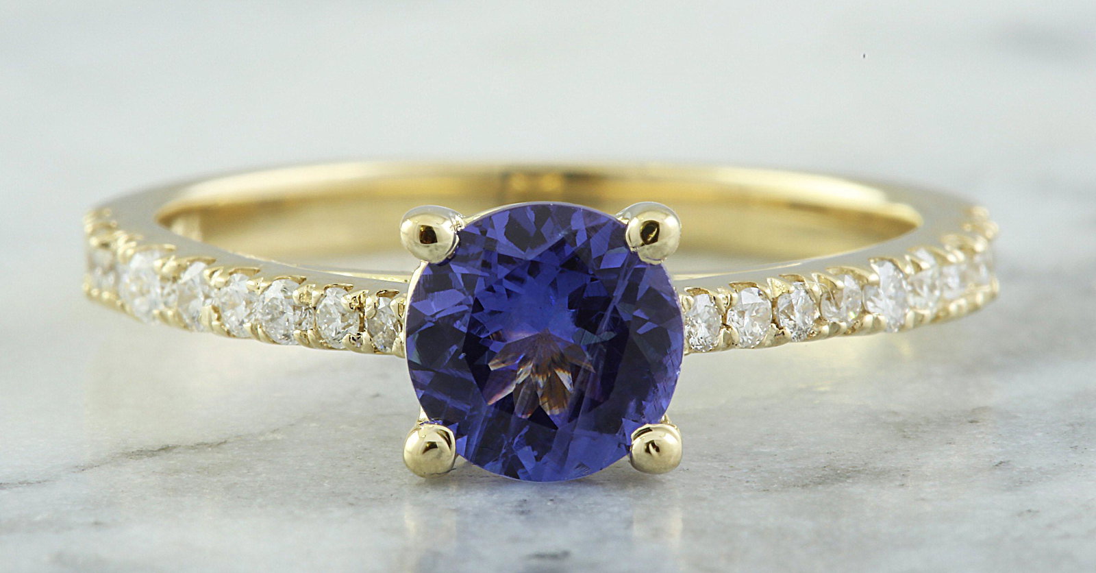 1.28 CTW Tanzanite 14K Yellow Gold Diamond Ring: 1.28 CTW Tanzanite 14K Yellow Gold Diamond Ring Manufacturer's Suggested Retail Price: $ 1900.00 Stamped: 14K Ring Size: 7 Total Ring Weight: 2.9 Grams Tanzanite Weight: 1.00 Carat (6.00x6.00 Millimet