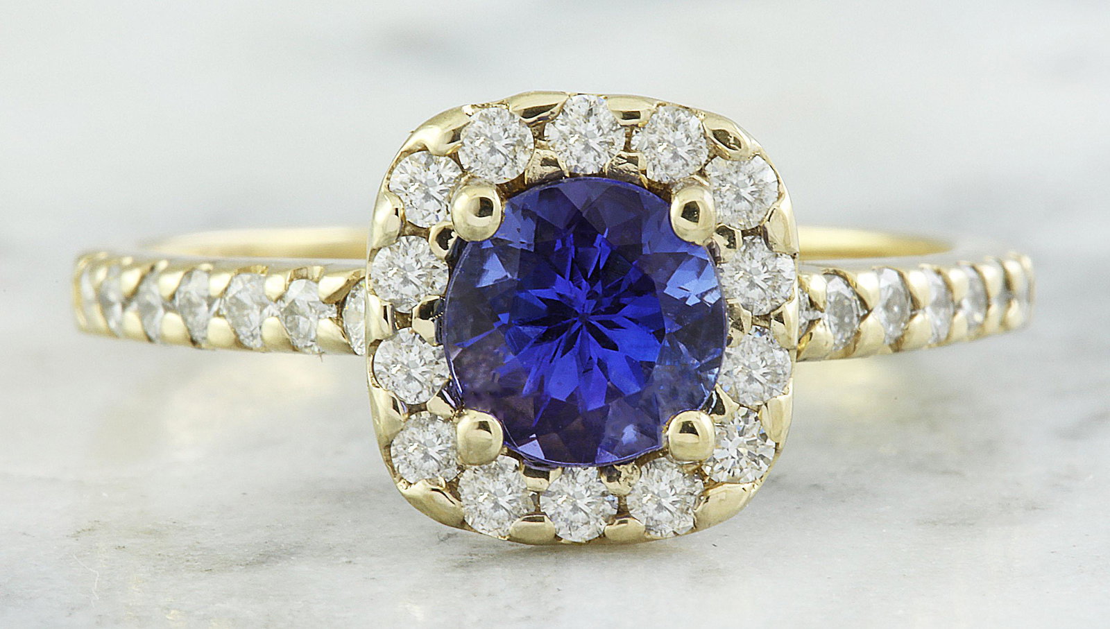 1.55 CTW Tanzanite 14K Yellow Gold Diamond Ring: 1.55 CTW Tanzanite 14K Yellow Gold Diamond Ring Manufacturer's Suggested Retail Price: $ 2500.00 Stamped: 14K Total Ring Weight: 3.4 Grams Tanzanite Weight 1.05 Carat (6.00x6.00 Millimeters) Diamond W