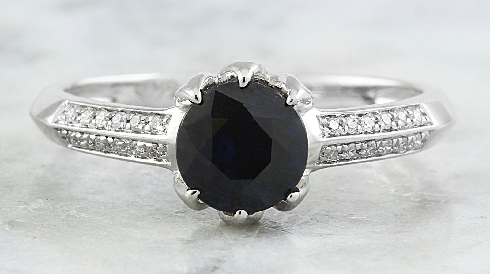 1.19 CTW Sapphire 18K White Gold Diamond Ring: 1.19 CTW Sapphire 18K White Gold Diamond Ring Manufacturer's Suggested Retail Price: $ 1900.00 Stamped: 18K Total Ring Weight: 2.4 Grams Sapphire Weight 1.05 Carat (6.00x6.00 Millimeters) Diamond Weig