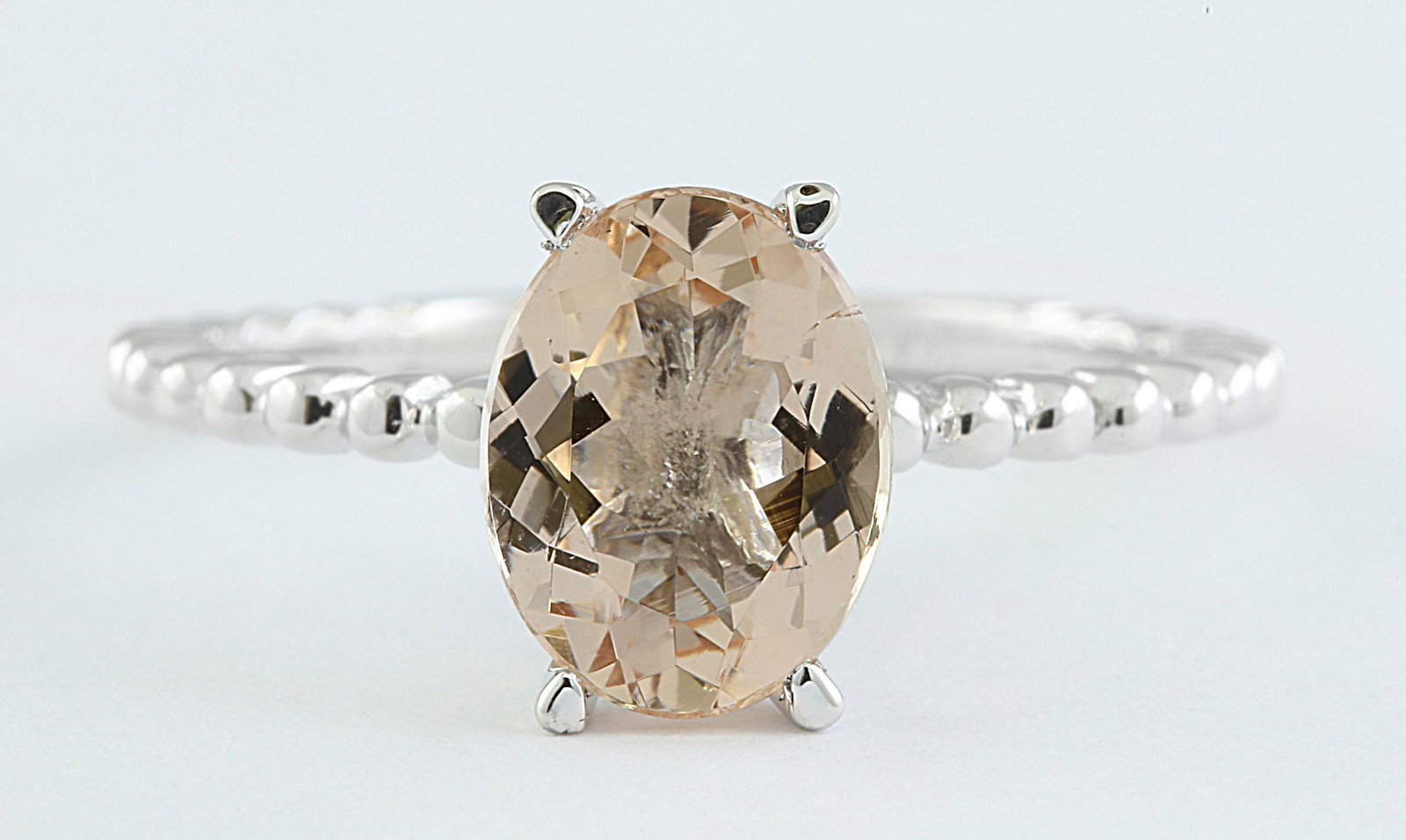 1.50 CTW Morganite 14K White Gold Ring: 1.50 CTW Morganite 14K White Gold Ring Manufacturer's Suggested Retail Price: $ 1200.00 Stamped: 14K Total Ring Weight: 2 Grams Morganite Weight: 1.50 Carat (9.00x7.00 Millimeters) Face Measures: 9.00